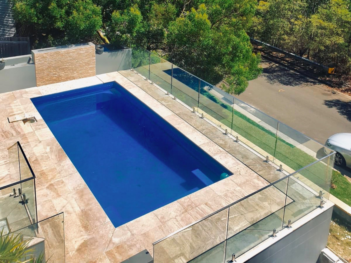 Glass pool fence with top rail
